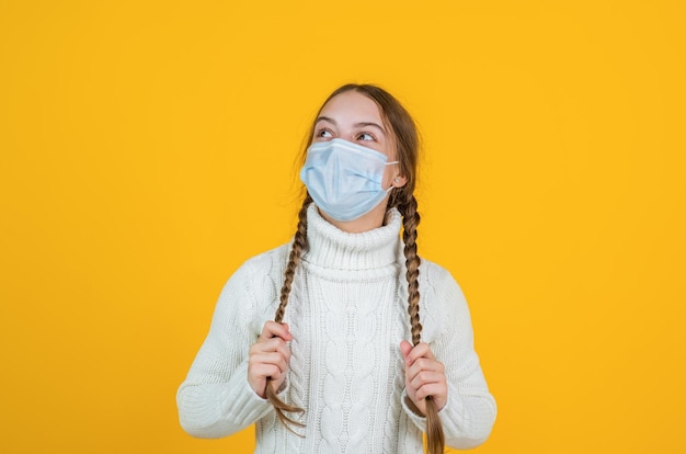 Girl child wearing respirator mask to protect from coronavirus virus