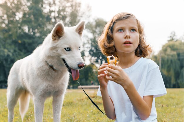 Girl child with a white dog Husky