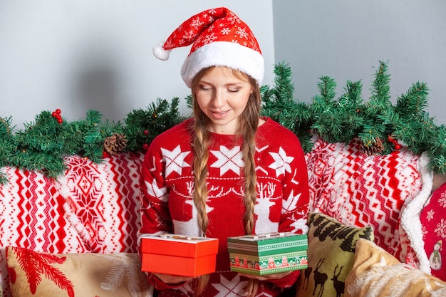 Girl Choosing From Two Christmas Gift Boxes in New Year's Holidays Decorations