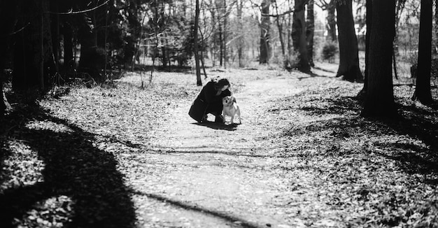 Girl in a coat hugging a dog