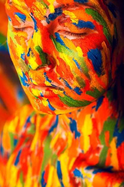 Girl in colourful paint strokes in studio