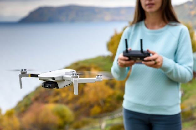 Girl controls a drone outdoors