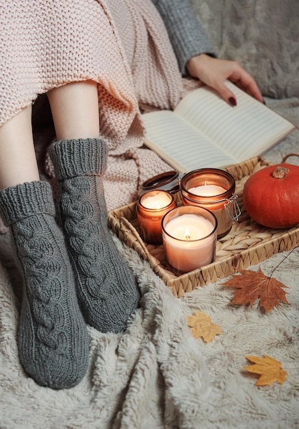 Girl covered with a blanket in knitted socks