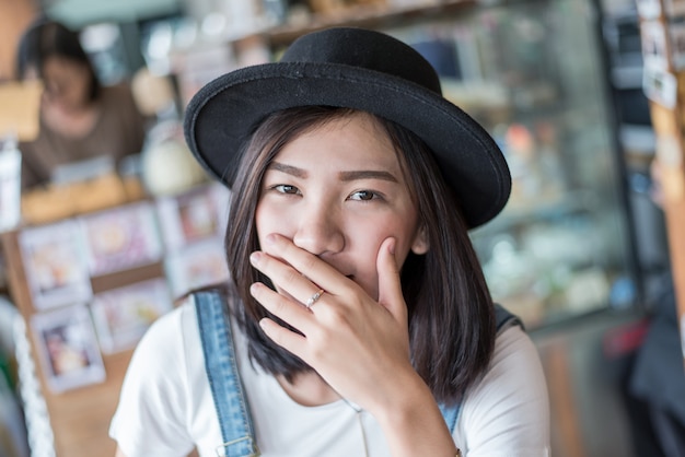 girl covers her mouth with her hands