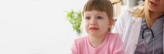 Girl cry at doctor office on consultation upset little girl dont like hospital