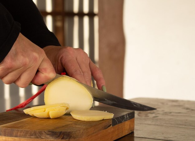 girl cuts cheese with a knife