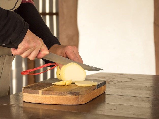 girl cuts cheese with a knife