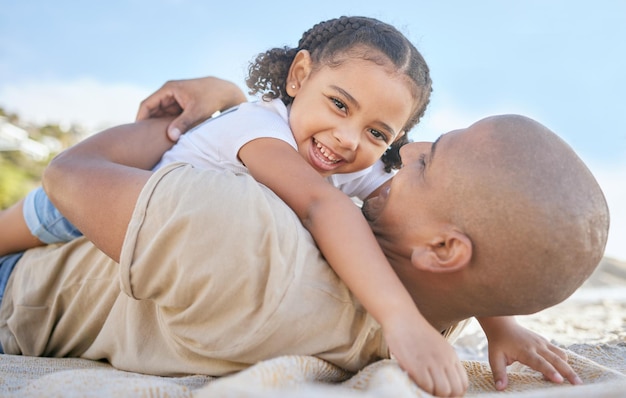 Girl dad and lying on blanket beach and smile on travel holiday or summer for family happiness and sand Happy child and father together with sunshine relax or hug at ocean bonding or vacation