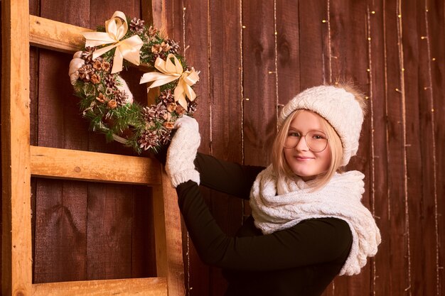 Girl decorating house for christmas