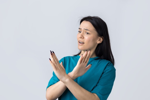 Girl disapproving with no crossing hands sign make negation gesture Portrait of pretty woman