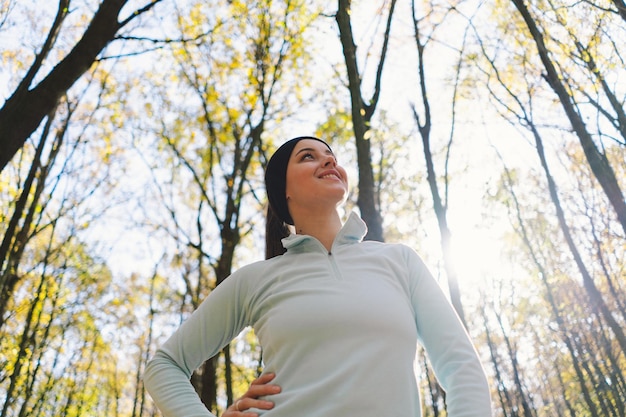 Girl doing fitness in nature on a sunny autumn forest