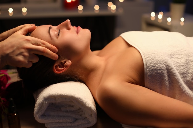 Girl doing relaxation head massage in beauty salon