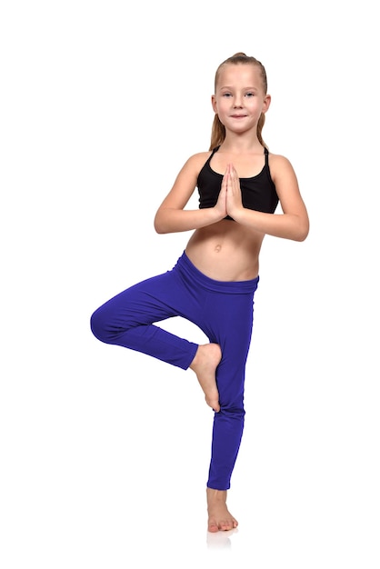 Girl doing yoga exercises in blue clothing