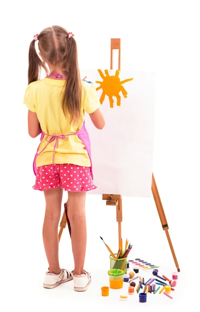 Girl draws a house and the sun artist kid girl painting over white background