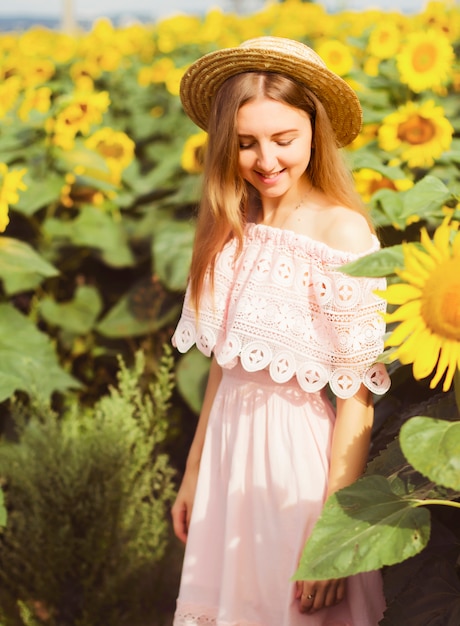 Girl in a dress among the sunflowers, the girl stands in a field of sunflowers