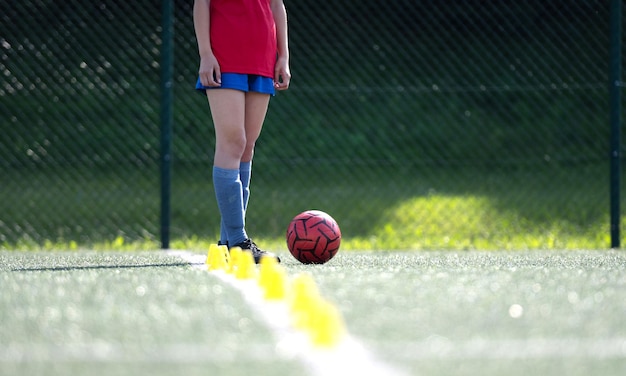 Photo girl dribbles ball between flip cups