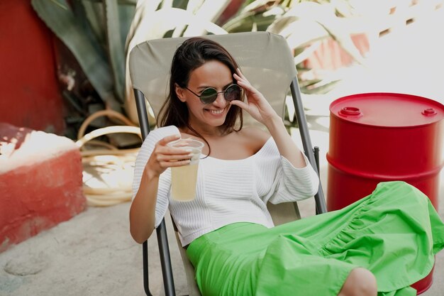 Girl drinking a cocktail on a summer terrace, lifestyle photo