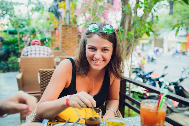 Girl drinking a cocktail at sunset