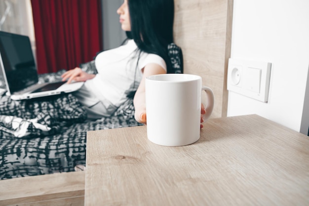 Girl drinking coffee in bed