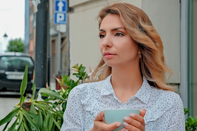 Girl drinking coffee on the street Street Cafe beautiful girl and coffee