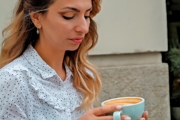 Girl drinking coffee on the street Street Cafe beautiful girl and coffee