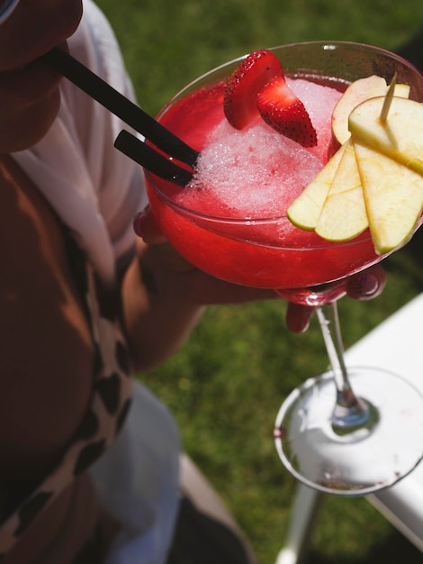 A girl drinking her colorful cocktail