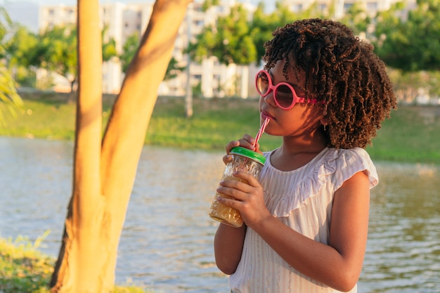 Girl drinking a juice at the park