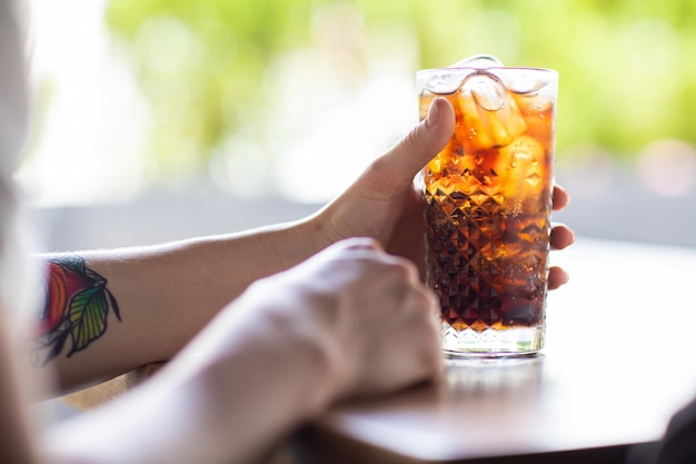 the girl drinks a delicious sweet cocktail and looks into the phone amazing relaxing day