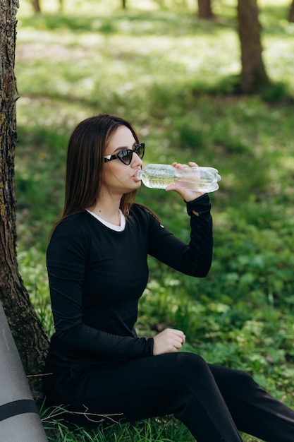 A girl drinks water after sport