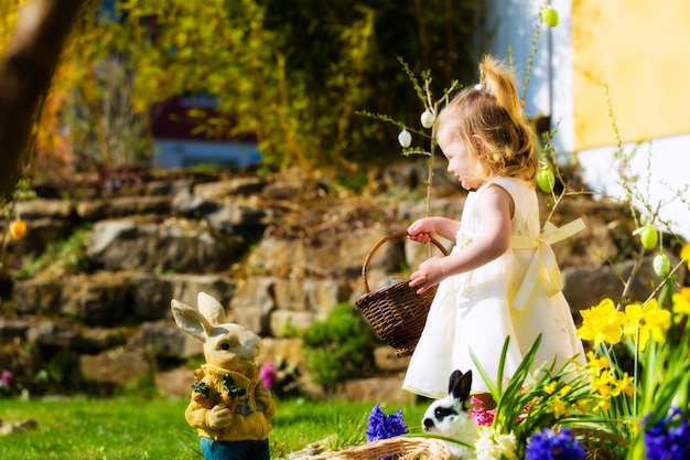 Girl on Easter egg hunt with eggs