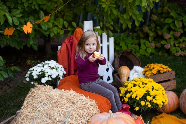 Girl eating apple in autumn