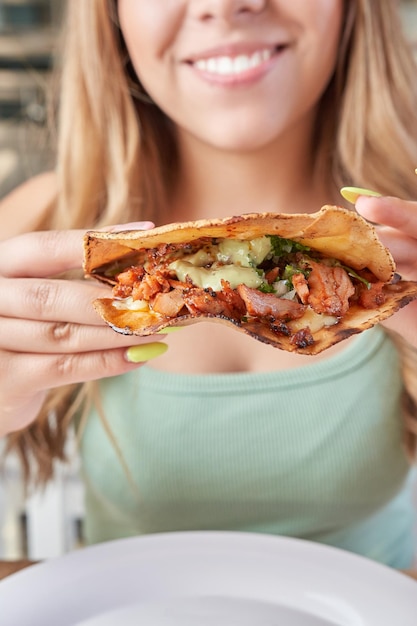 Girl eating delicious typical mexican food tacos sopes pastor etc