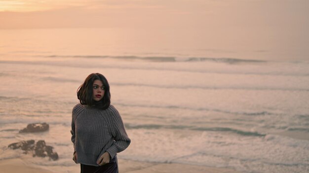 Girl enjoy cloudy seascape standing near ocean waves woman standing seashore