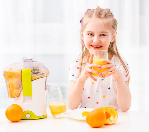 Girl enjoying glass of orange juice