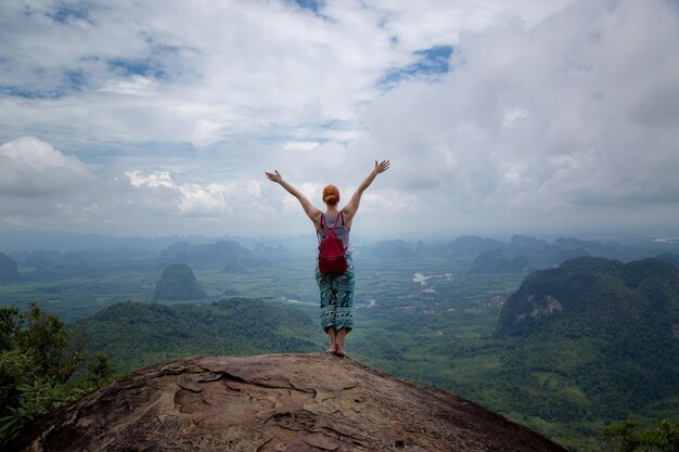 Girl enjoys a beautiful view of the valley and the Andaman Sea islands and mountains from the viewpoint Krabi Thailand