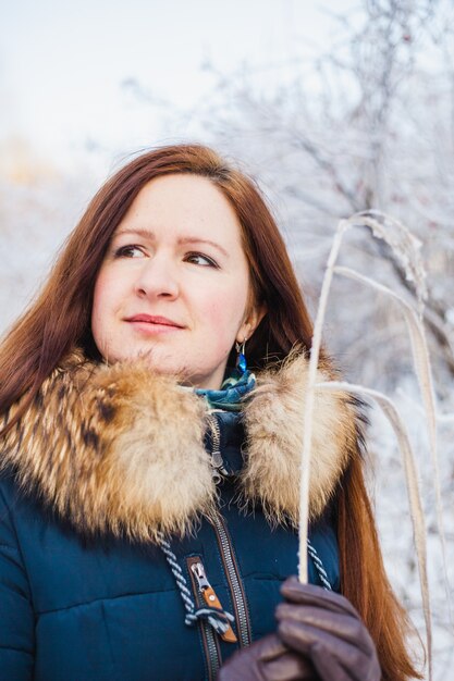 Girl of European appearance on a walk in the winter forest, Park, winter and snow, health, winter clothes, jacket