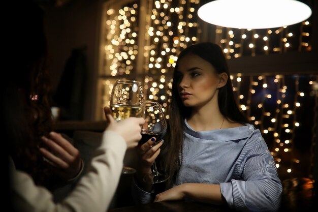 The girl in the evening rest in a cafe for a cocktail