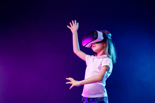 Girl experiencing VR headset game. Child using a gaming gadget for virtual reality.