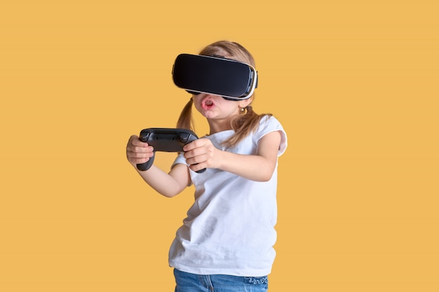 Girl experiencing VR headset vs joystick game. Surprised emotions on her face. Child using a gaming gadget for virtual reality.