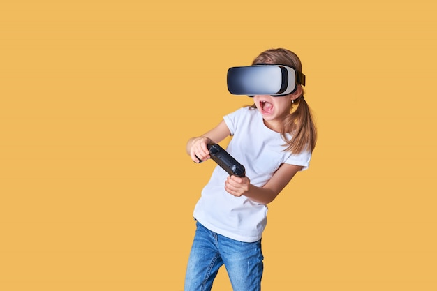 Girl experiencing VR headset vs joystick game. Surprised emotions on her face. Child using a gaming gadget for virtual reality.