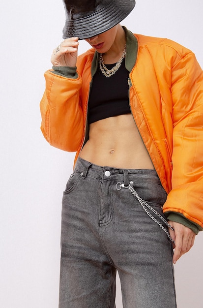 Girl in fashion urban street outfit Trendy orange bomber jacket