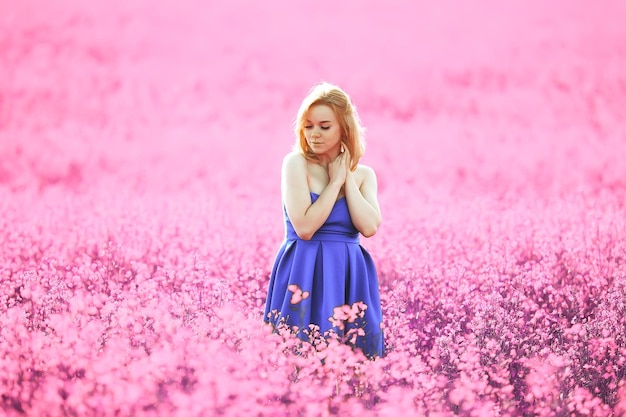 girl in a field of lilac flowers in lavender colors, violet and pink landscape, happy and harmony