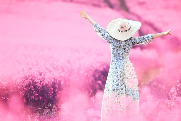 girl in a field of lilac flowers in lavender colors, violet and pink landscape, happy and harmony