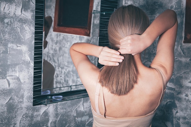 Girl fixing her long hair