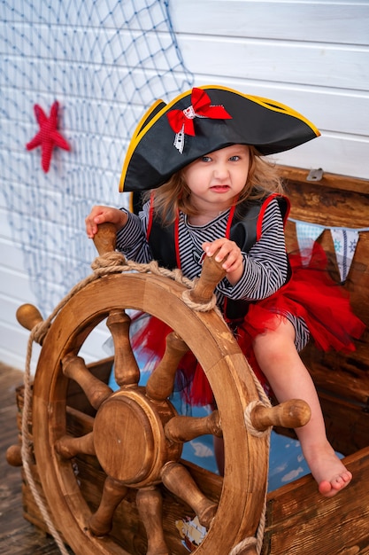 Girl in the form of pirates at the helm. holiday decoration pirate style