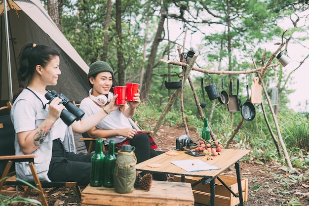 Girl and friends camping in the forest