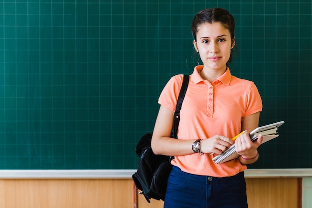 Girl in front of the blackboard