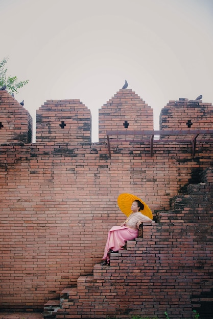 Girl in front of historical Tha Phae gate at Old city in Chiang Mai Thailand