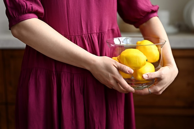 Girl in fuchsia dress holding lemons