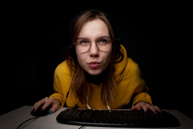 Girl gamer playing a video game at night